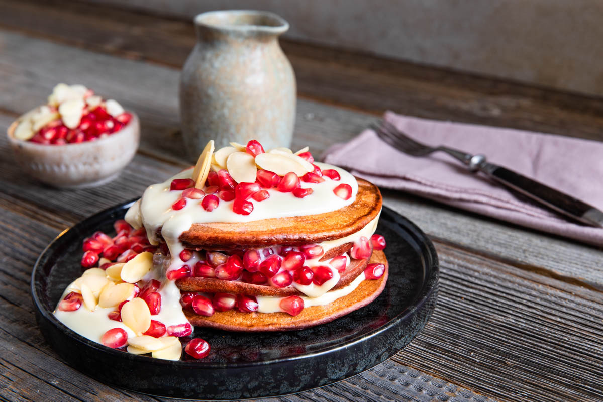 Red velvet pancakes met granaatappel en witte chocoladesaus
